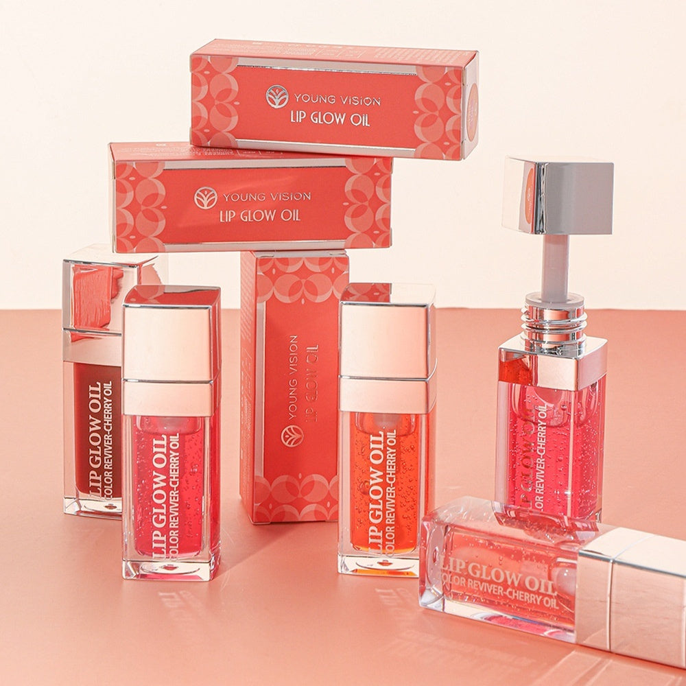 Young Vision Lip Glow Oil packaging on a peach background