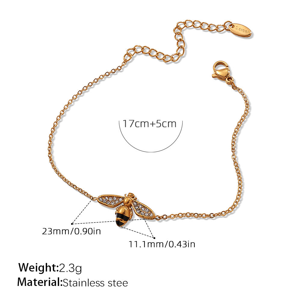 Gold bracelet with measurements and material details on a white background