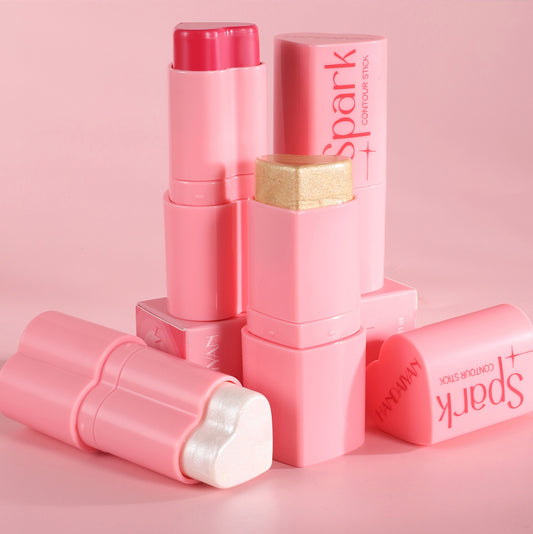 Pink makeup stick with 'Spark' branding on a pink background